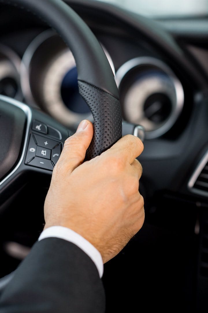 chauffeur hand on a wheel