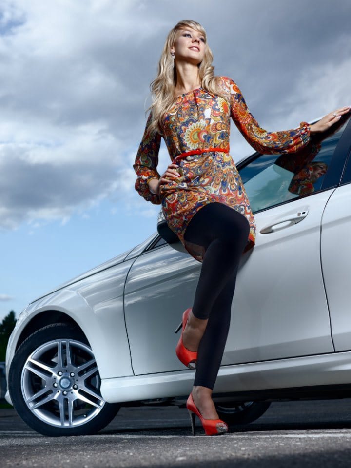 Woman posing by the car