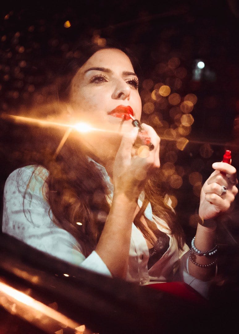 Woman doing make up in the car