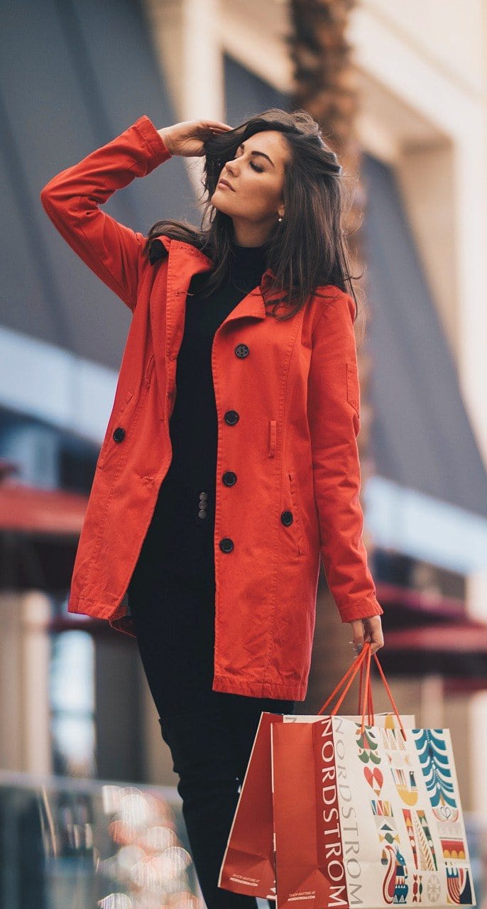 Woman in red coat posing