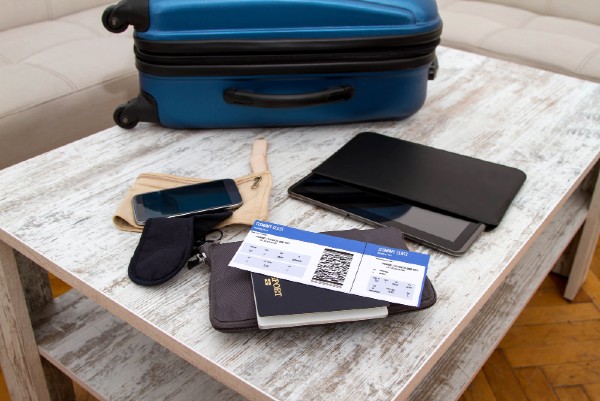 Suitcase on the table, telephone, passport and tickets